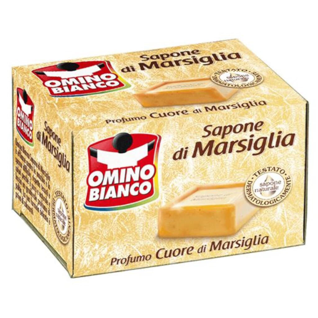 Опаковка на Omino Bianco Sapone Solido di Marsiglia Profumo Cuore di Marsiglia (250 мл), показваща сапуна и логото на марката.